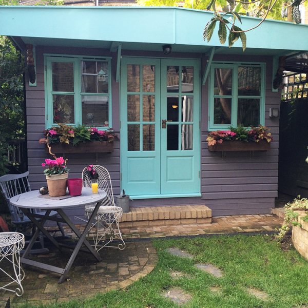 Juju Vail's garden painting studio with turquoise doors